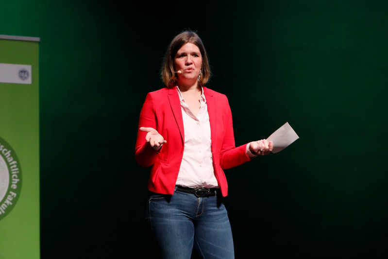 Alumna speaking on stage during graduation ceremony