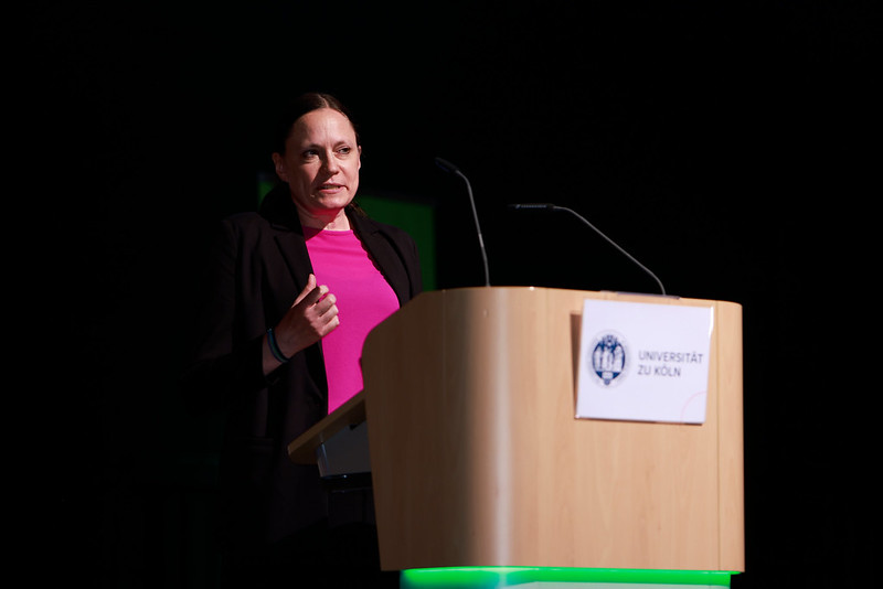 Alumna speaking on stage during graduation ceremony