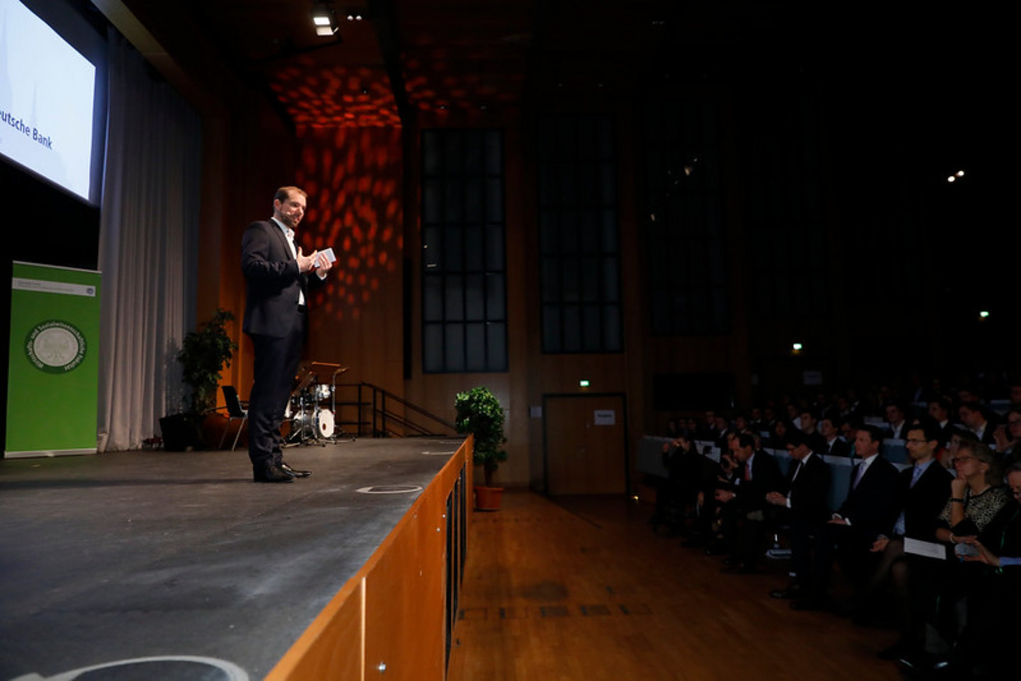 Alumnus speaking on stage during graduation ceremony