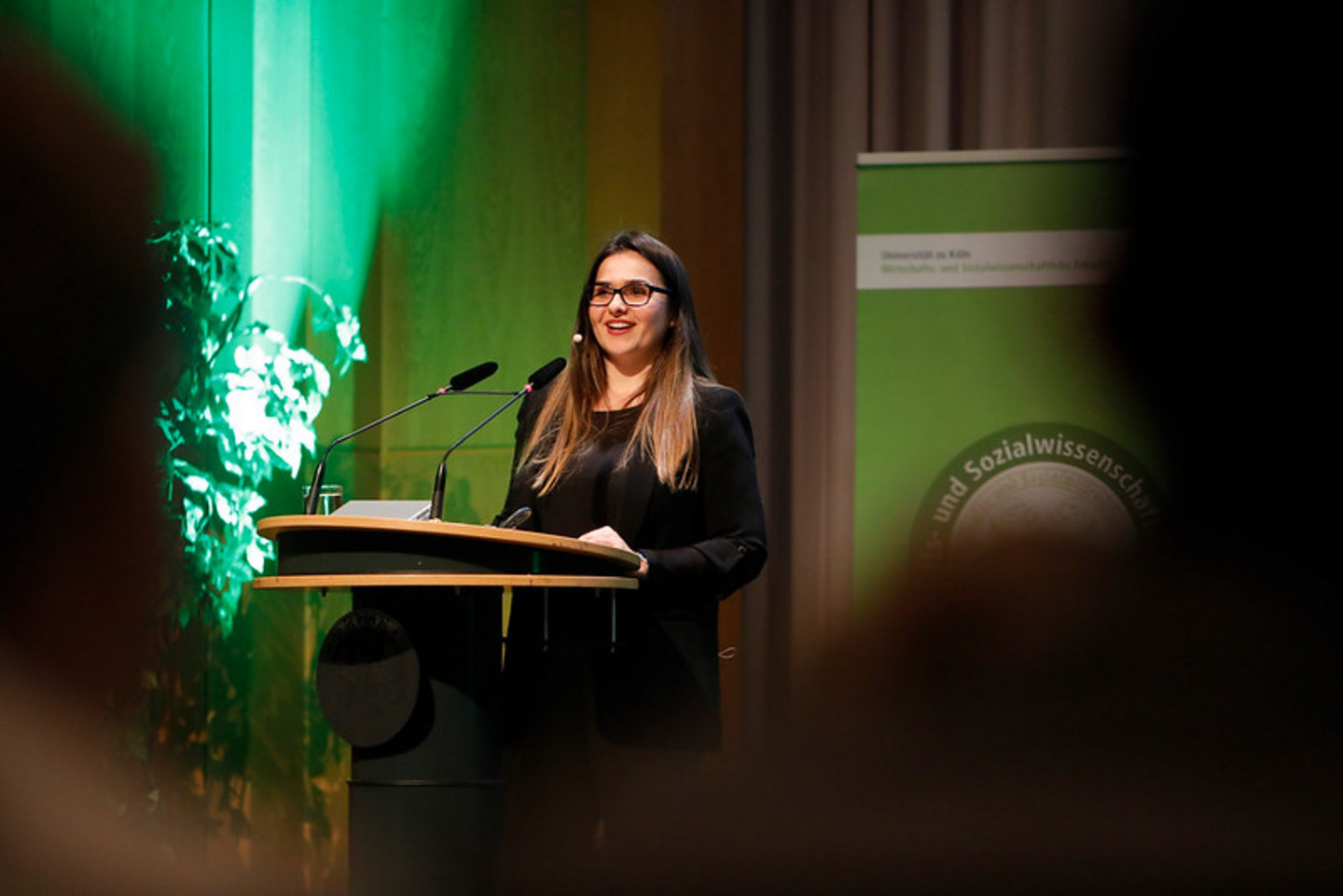 Alumna speaking on stage during graduation ceremony