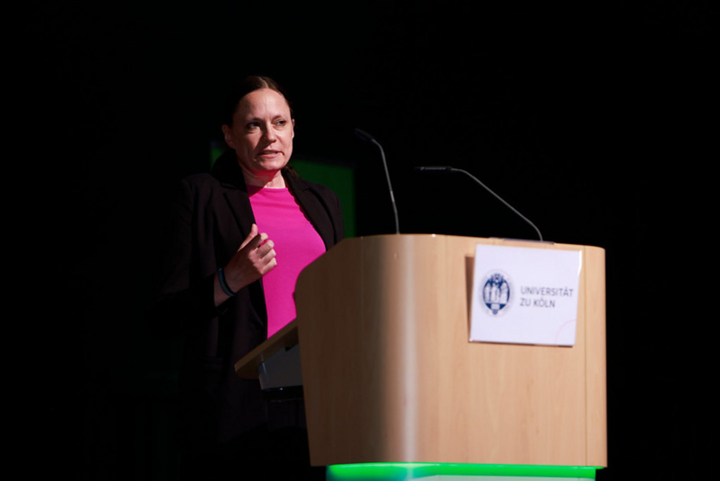 Alumna speaking on stage during graduation ceremony