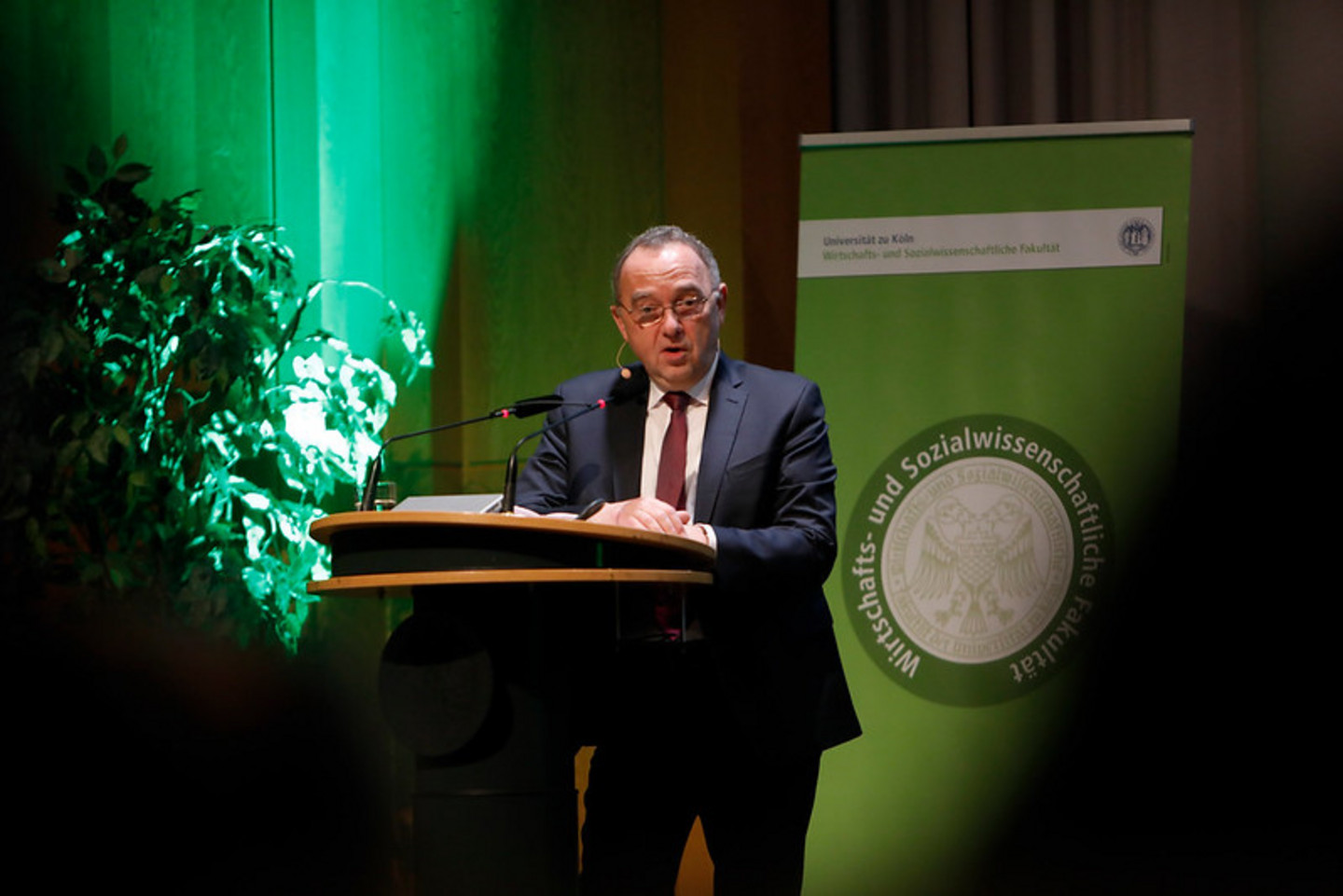 Alumnus speaking on stage during graduation ceremony