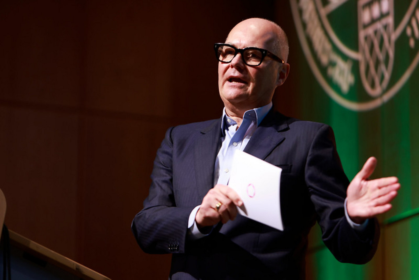 Alumnus speaking on stage during graduation ceremony