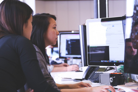 Two people looking at a computer screen