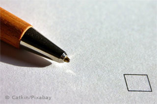 A rollerpen and a tick box on a grey background