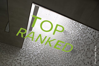View from the bottom to the top of an architecturally modern staircase. Text: "Top ranked"